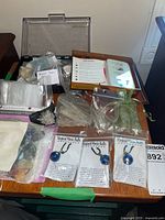 Overview of lot showing Magical Music Balls, organza pouches, plastic and wooden cases, quartz cluster, fossil stone, bonbonniere bag pack, and labeled zip bag stones