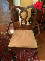 Front view of chair showing carved back splat and upholstered seat