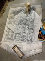 Photo of spread-out nautical charts showing detailed waterway maps with depth soundings and navigational info.