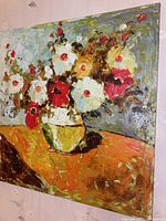 Front view of full acrylic floral painting on canvas hanging on a wall, showing the bouquet in a yellow vase on an orange table with background tones of blue and gray.