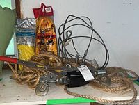 Photo showing the winch, ropes in packaging, natural fiber ropes, and metal hooks clustered on shelf