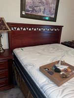 Full view of queen headboard, mattress and box spring on frame
