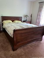 Front view of bed frame with headboard, footboard and bedding