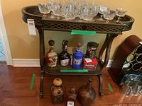 Full view of the wood stand with glassware and bottles on shelves, showing the overall size and design.