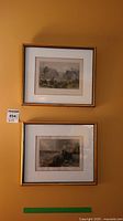 Two framed and matted vintage prints hung on a wall, showing the art and framing style.