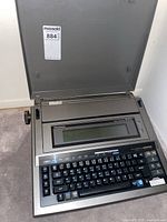 Open Panasonic KE-W900 word processor showing keyboard, screen, and printer