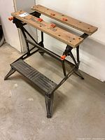 Front and side views of Black and Decker Workmate 300 with wooden jaws and metal frame, showing overall condition and clamp handles.
