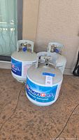 Front view of three AmeriGas propane cylinders on patio