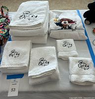All seven towels displayed: two bath, two hand, two washcloths with Mickey embroidery and one Pirate Mickey bath towel