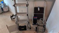 Group shot showing ladder, hand truck, packaged safety mat, platform panel, case and board