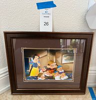 Front view of framed Snow White and Seven Dwarfs print showing frame and mat
