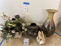 Group shot of all items: faux floral basket, two ceramic vases, seashell vase, paprika tin
