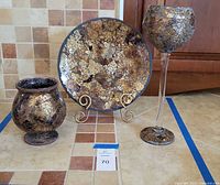 Full view of three matching mosaic glass pieces: plate on stand, vase, goblet