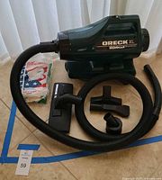 Full lot view with vacuum, hose, attachments and bag pack