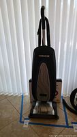 Front view of Oreck upright vacuum standing on floor