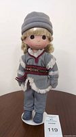 Front view of Kristoff doll on stand showing outfit and accessories
