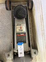 Top view of Sears hydraulic floor jack showing label and saddle