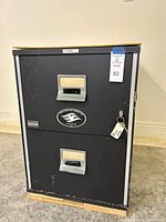 Front view showing two drawers, handles, lock with key and Fire Master logo