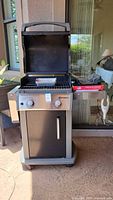Weber Spirit gas grill open showing interior accessories