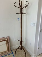 Full view of wooden coat tree against wall