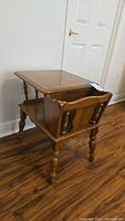 Oblique view of wooden side table showing magazine rack and legs