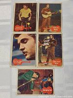 Five vintage Elvis Presley cards from 1956, showing varied titles and images related to Elvis Presley in different poses and scenes.