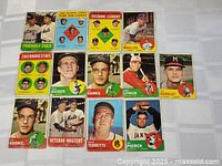 Photo of 13 vintage 1963 Topps baseball cards laid flat on a white surface showcasing a mix of players and leader types.