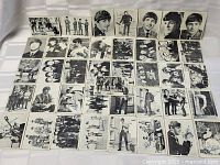Full layout of all 40 black and white Beatles 1964 trading cards arranged in rows displaying various images of the band members.