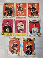 Photo showing nine Boston Bruins hockey cards from 1967-1972, including Ted Green, Johnny Bucyk, Wayne Carleton, Ron Murphy, Fred Stanfield, Don Marcotte, Ken Hodge, and Wayne Cashman.
