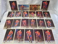 Full group view of 22 Montreal Canadiens player postcards arranged in rows against white background. Players shown in red Canadiens uniforms with hockey sticks, skates, and goalie equipment. Various player poses including skating and goaltending.