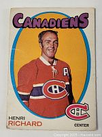 Front of vintage hockey card showing Henri Richard of the Montreal Canadiens with bright yellow background and team branding.