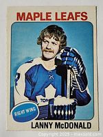 Front side of the 1975-76 OPC Lanny McDonald hockey card showing player portrait in Toronto Maple Leafs uniform.