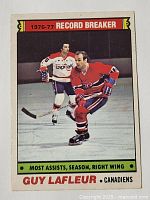 Front of the 1977-78 OPC hockey card featuring Guy Lafleur in a red Montreal Canadiens uniform skating during a game, highlighting him as the 1976-77 record breaker for most assists in a season, right wing.