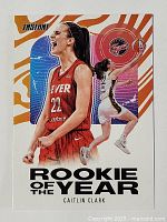 Front of the Caitlin Clark rookie card showing her celebrating in red Iowa Fever uniform with Rookie of the Year text and orange, purple background design.