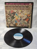 Photo of colorful illustrated front cover and vinyl record with Chess Records label