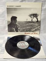 Photo of Corey Hart Fields of Fire LP vinyl record on cover, showing record partially out of sleeve on a white textured surface.