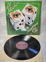 Open view with the LP vinyl record partially out of its cover, showing the purple Capitol Records label on the vinyl.