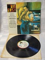 Vinyl LP record partially pulled out to show the label and surface condition, indicating very good condition of vinyl with original Capitol Records label.