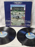 Photo showing the Hooligans album cover with two vinyl records out of the sleeve, both in very good condition with visible Columbia Records rainbow labels.