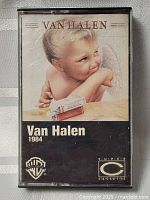 Front of Van Halen 1984 cassette tape case showing album cover with cherub photo and Warner Bros logo.
