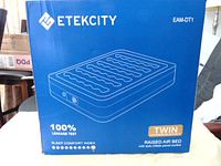 Front view of the sealed Etekcity air mattress box showing model EAM-DT1, Twin size, 18 inches thick, 75 inches long, 39 inches wide, with 100% leakage test and sleep comfort index.