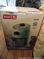 Box of Dash compact air fryer showing the product image and branding in mint condition with a MaxSold label.