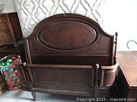 Photo of vintage wooden double bed frame with curved headboard and footboard, and sideboards.