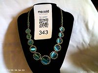 Full front view of the Joan Rivers necklace featuring blue cat's eye stones on a chain.