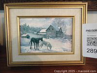 Framed print showing a winter scene with two horses and a cabin, signed by Keirstead.