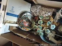 Box showing Christmas plate, candle holder, white decorative tray and other miscellaneous items