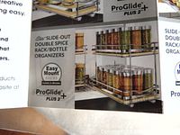 Photo of packaging showing Elite ProGlide Plus 2 slide-out double spice rack with easy mount system and chrome metal two-tier design with guard rails.