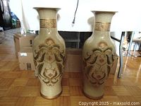 Two tall ceramic vases side by side, showing overall shape and decorative patterns.