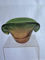 Front view of vintage Murano art glass clam shell form bowl vase showing amber to green sommerso color layering.