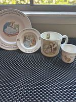 Photo showing all 4 items of the Peter Rabbit Wedgwood children's set displayed in a row